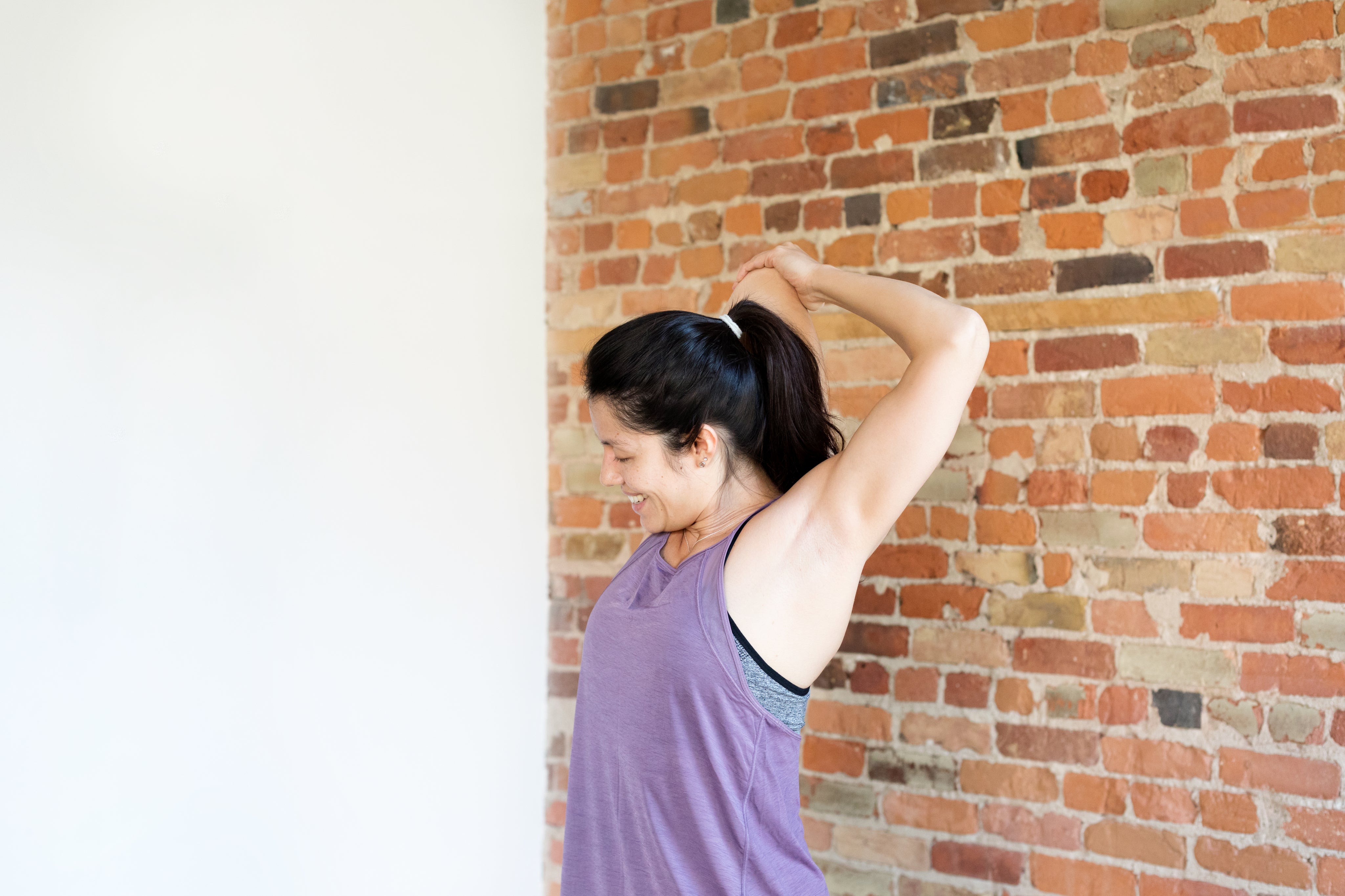 files/young-woman-exercising-in-workout-clothes-against-brick-wall.jpg